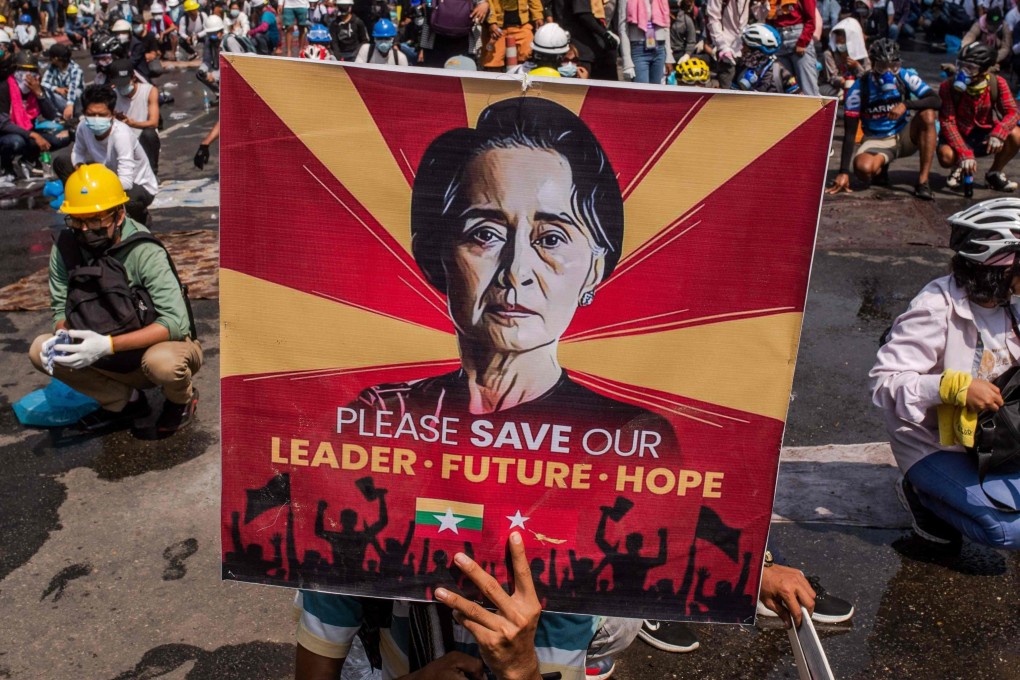 A protester holds a poster featuring Aung San Suu Kyi in a 2021 protest in Yangon, Myanmar. File photo: AFP