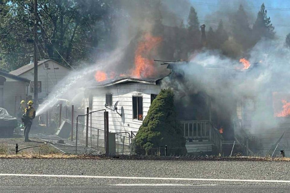 Firefighters battle flames at a home near Weed, California, on September 2. Photo: The Sacramento Bee/TNS