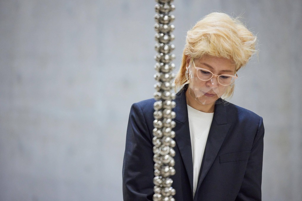 South Korean artist Haegue Yang at M+ with part of her work “Sonic Rescue Ropes” (2022). Photo: Dan Leung courtesy of M+ Hong Kong