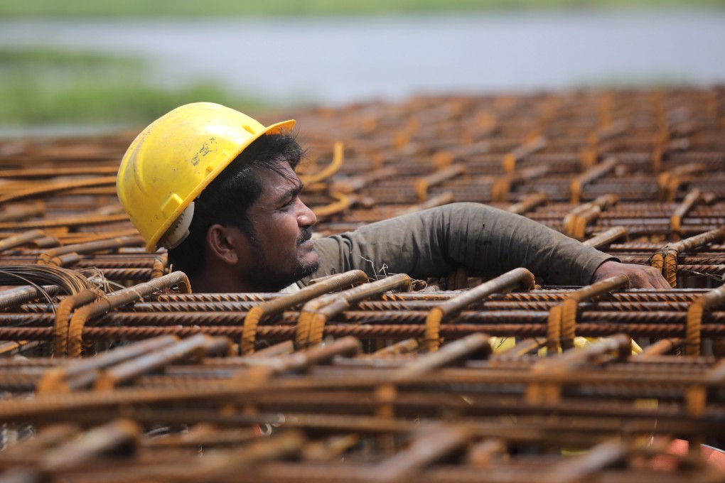 A labourer works on a construction site near Kolkata, India, on May 2. Some two-thirds of all workers in the Asia-Pacific region are employed informally, often on low wages, in hazardous conditions and without a contract. Photo: EPA-EFE