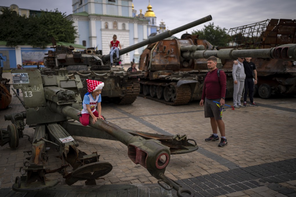 Children play on destroyed Russian military vehicles in central Kyiv, Ukraine on Saturday. Several children were killed and injured as a result of Russian attacks and the negligent handling of ammunition on Saturday. Photo: AP