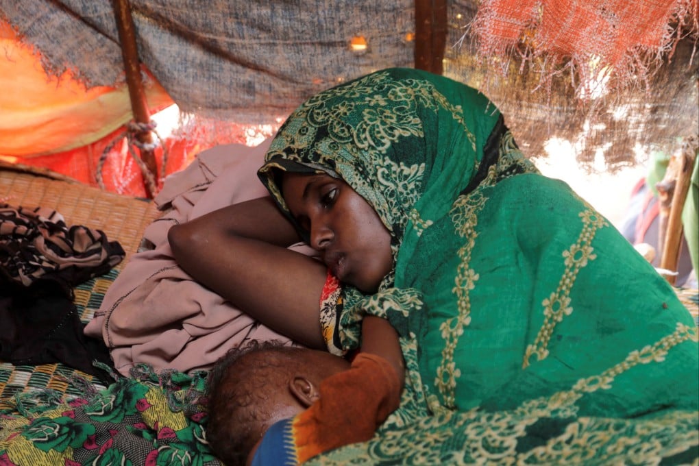 Abdia Aden Mohamed rests with her eight-month-old baby inside a makeshift shelter at a camp for internally displaced people in Somalia. File photo: Reuters