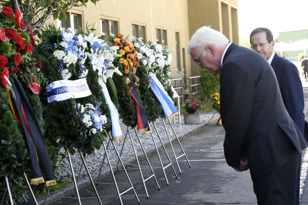 Israel’s President Isaac Herzog (R) looks on as German President Frank-Walter Steinmeier bows after laying a wreath during a ceremony marking the 50th anniversary of a fatal attack on the 1972 Munich Olympics. Photo: AFP