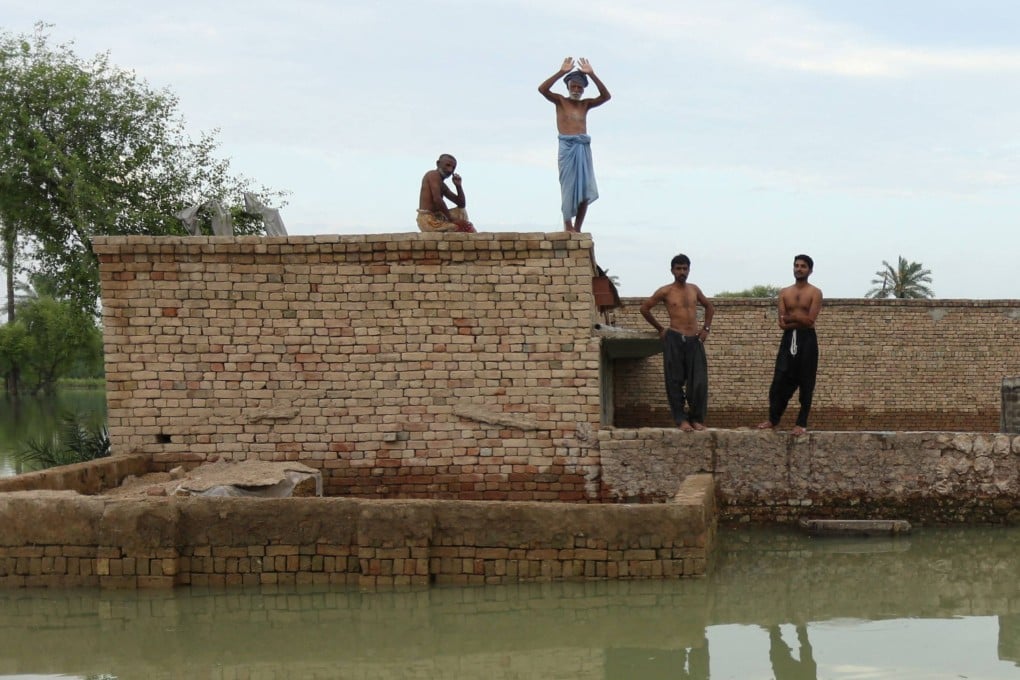 Flood-affected people wait for relief supplies in Dera Ghazi Khan district in Punjab province. Tens of millions of people across Pakistan are battling the worst monsoon floods in a decade, with countless homes washed away, vital farmland destroyed and the country’s main river threatening to burst its banks. Photo: AFP