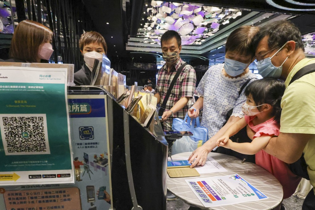 Patrons scanning the ‘Leave Home Safe’ app to enter a restaurant. Hong Kong will extend this measure to children as young as five. Photo: Dickson Lee