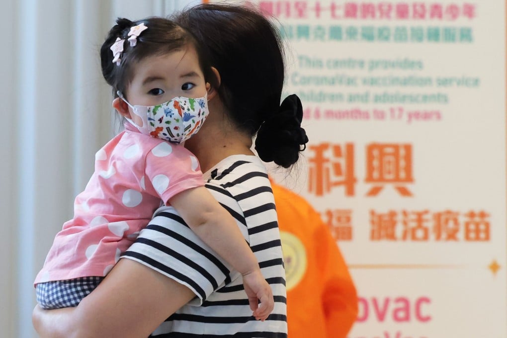 A little girl is taken to receive a Sinovac vaccination at Hong Kong Children’s Hospital. Photo: Jelly Tse
