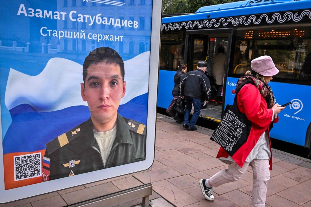 A pedestrian in Moscow walks past a billboard displaying a Russian soldier with a slogan reading ‘Glory to the Heroes of Russia’. Photo: AFP