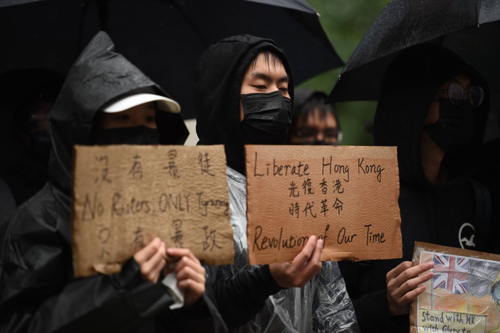 Protesters hold up placards in Manchester, United Kingdom, in sympathy with the pro-democracy demonstrations against China. Photo: AFP