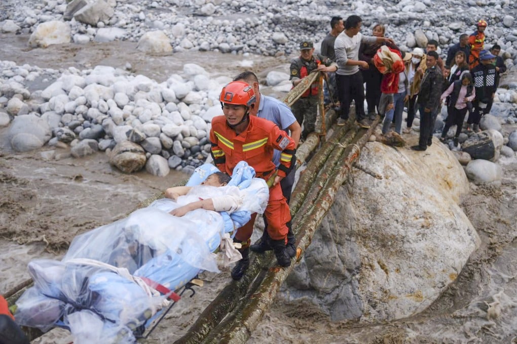 Rescuers transfer survivors across a river following an earthquake in China’s Sichuan Province. Photo: AP