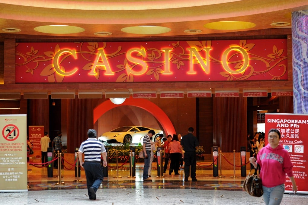 People walk near the entrance to the Resorts World Sentosa casino in Singapore. The city state replaced Macau as host of G2E Asia, one of the world’s biggest gaming conferences, for the first time this year. Photo: AFP