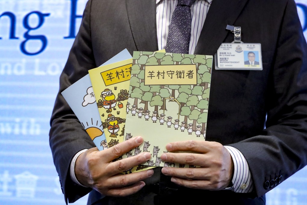 Li Kwai-wah, senior superintendent of Police National Security Department, poses with three children’s books that allegedly protray mainland China in a negative light. Photo: SCMP