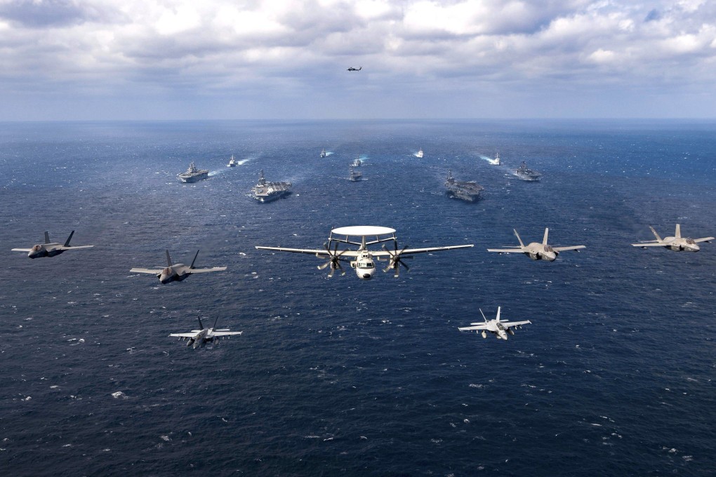 US and Japanese combat aircraft fly in formation above both countries’ warships during joint military drills held in the Philippine Sea earlier this year. Photo: US Navy Handout