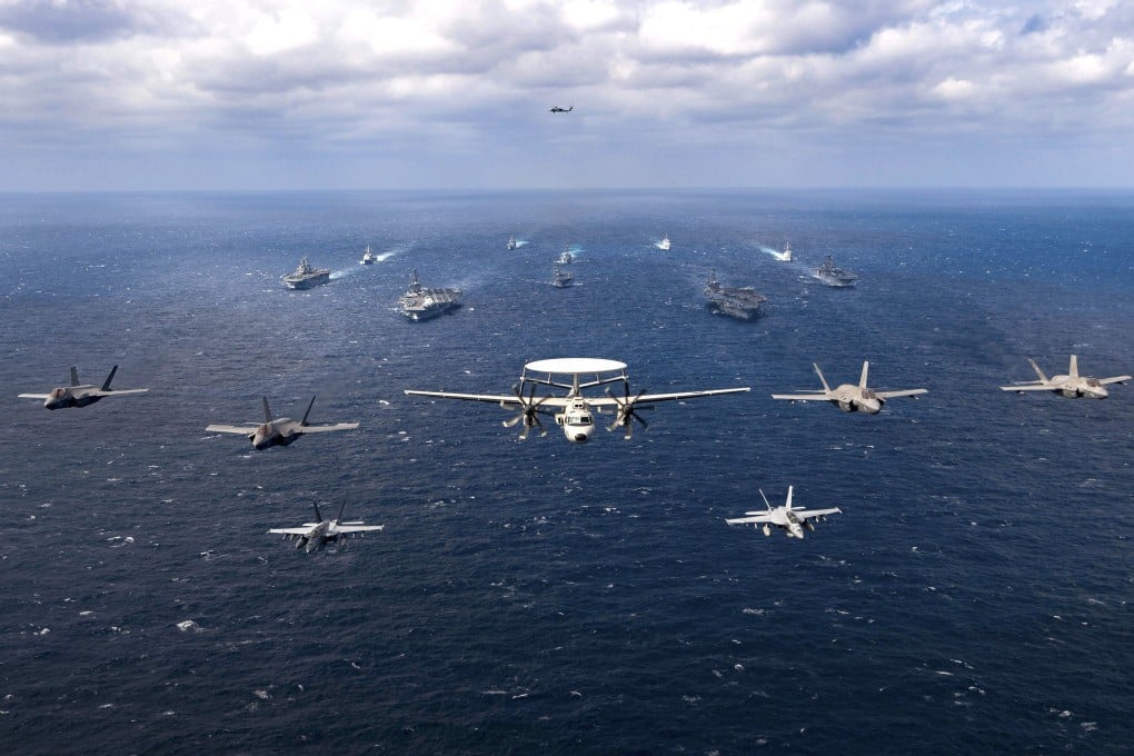 US and Japanese combat aircraft fly in formation above both countries’ warships during joint military drills held in the Philippine Sea earlier this year. Photo: US Navy Handout
