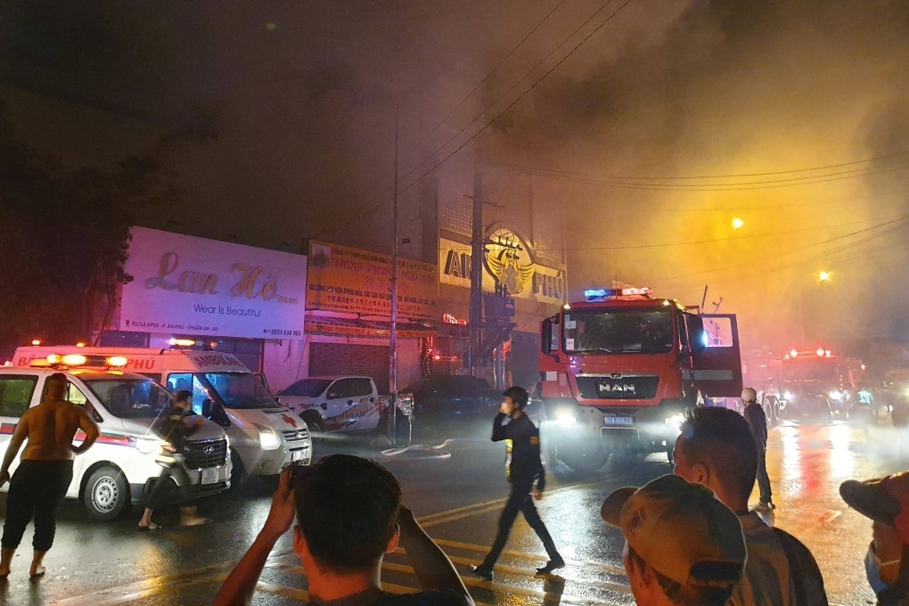 Firefighters at the scene of a deadly blaze that engulfed a karaoke bar in Thuan An, Vietnam’s Binh Duong province, on Tuesday night. Photo: Vietnam News Agency / AFP