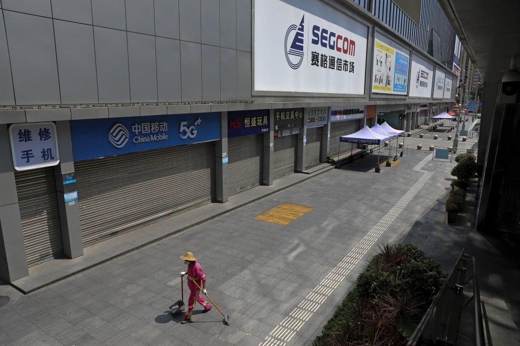 A cleaner walks by the shuttered Huaqiangbei Electronics Market in Shenzhen on September 3. Photo: Chinatopix Via AP