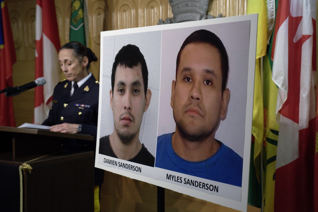 Assistant Commissioner Rhonda Blackmore speaks next to images of Damien Sanderson and Myles Sanderson during a press conference in Regina, Saskatchewan, on Sunday. Photo: Canadian Press via AP