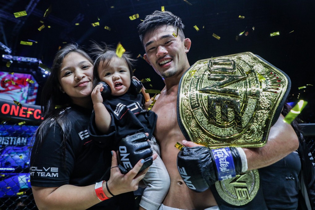 Christian Lee (right) with his wife and daughter after winning back the ONE lightweight title. Photos: ONE Championship