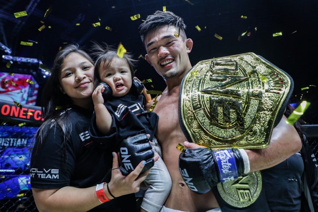 Christian Lee (right) with his wife and daughter after winning back the ONE lightweight title. Photos: ONE Championship