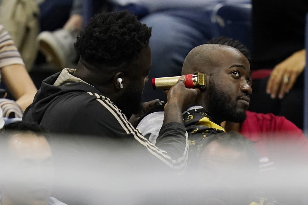 YouTuber JiDion gets trim while Nick Kyrgios plays Karen Khachanov at the US Open. Photo: AP