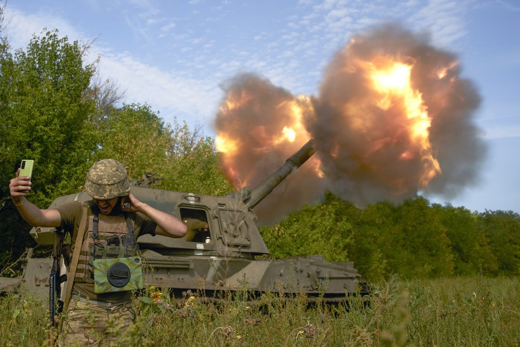 A Ukrainian soldier takes a selfie as an artillery system fires in Donetsk region, eastern Ukraine. Photo: AP