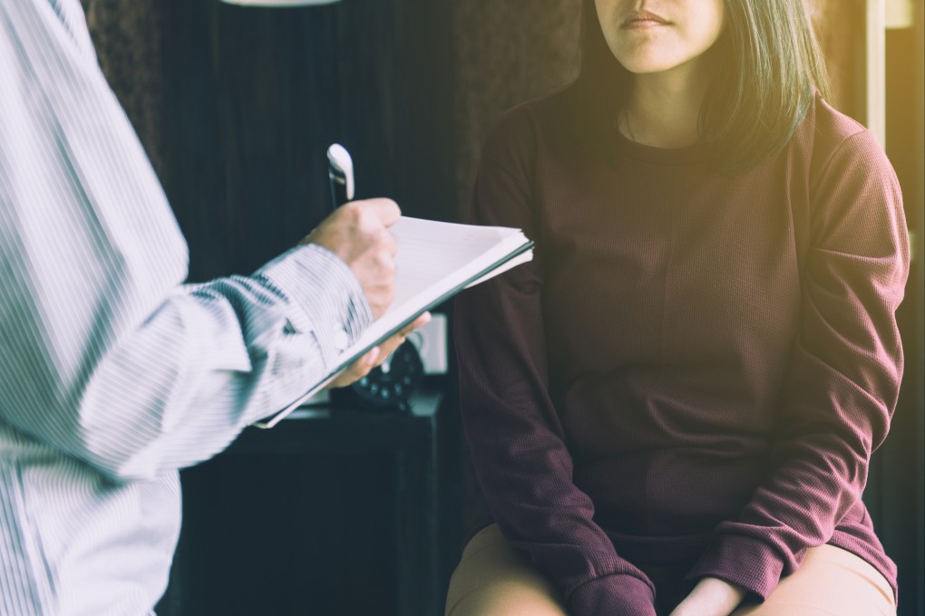 Professional psychiatrist talking to female patient about mental health. Photo: Shutterstock