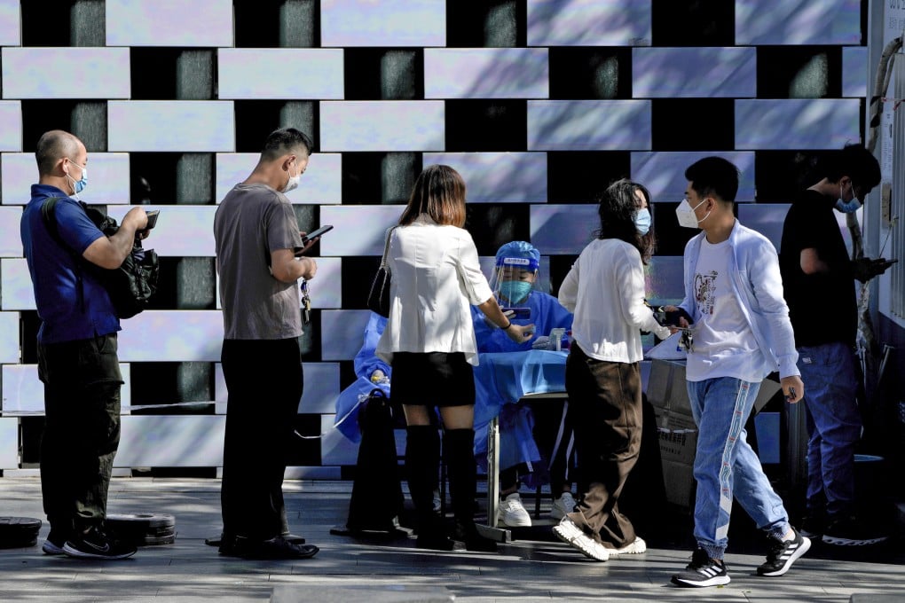 Residents line up to register for routine Covid-19 swabs at a testing site in Beijing on Monday. Photo: AP
