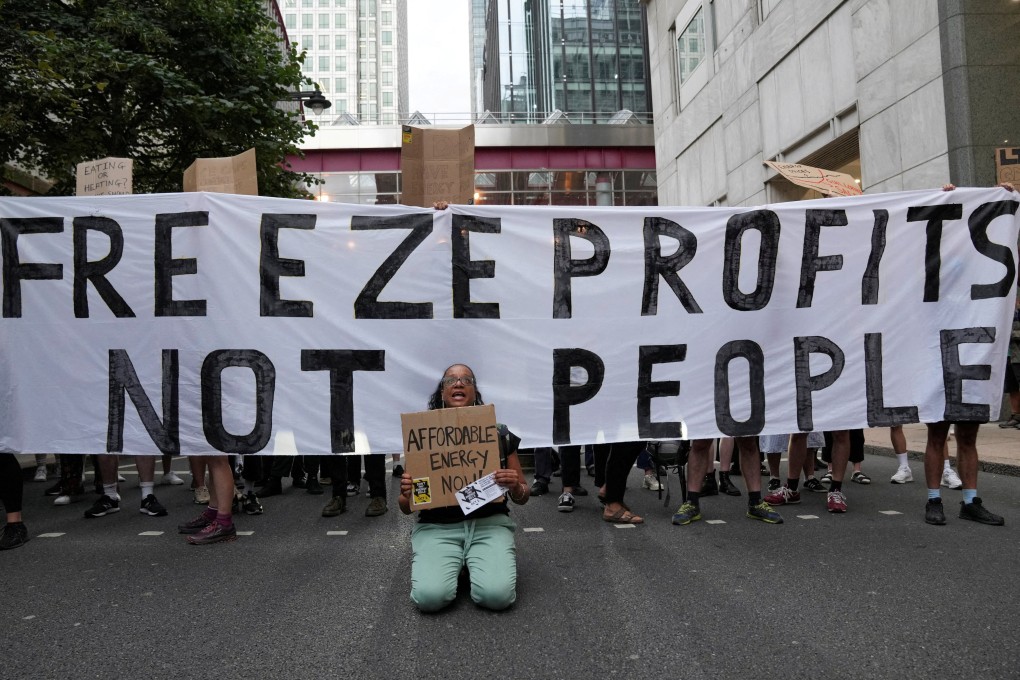 Demonstrators block a street in Canary Wharf during a protest outside the Ofgem headquarters in London on August 26. Britain’s struggles look set to continue as an inexperienced government faces multiple crises. Photo: Reuters