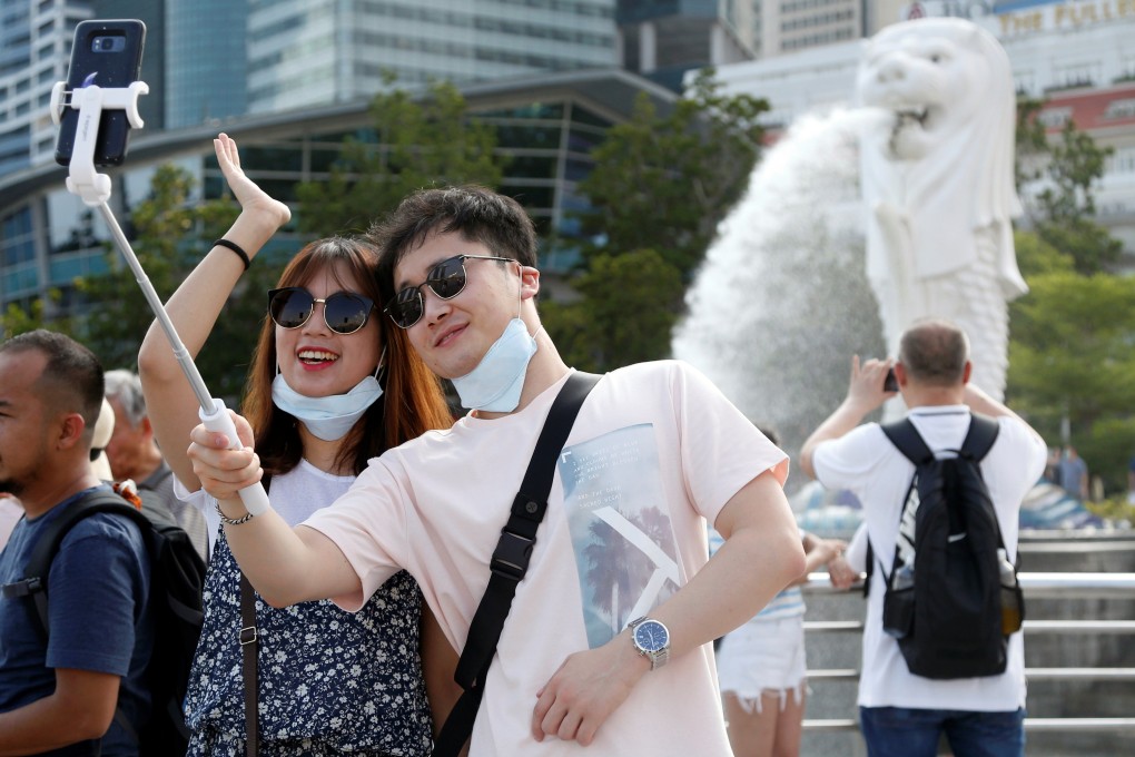 Tourists take a selfie in Singapore’s Merlion Park in January 2020. Photo: Reuters