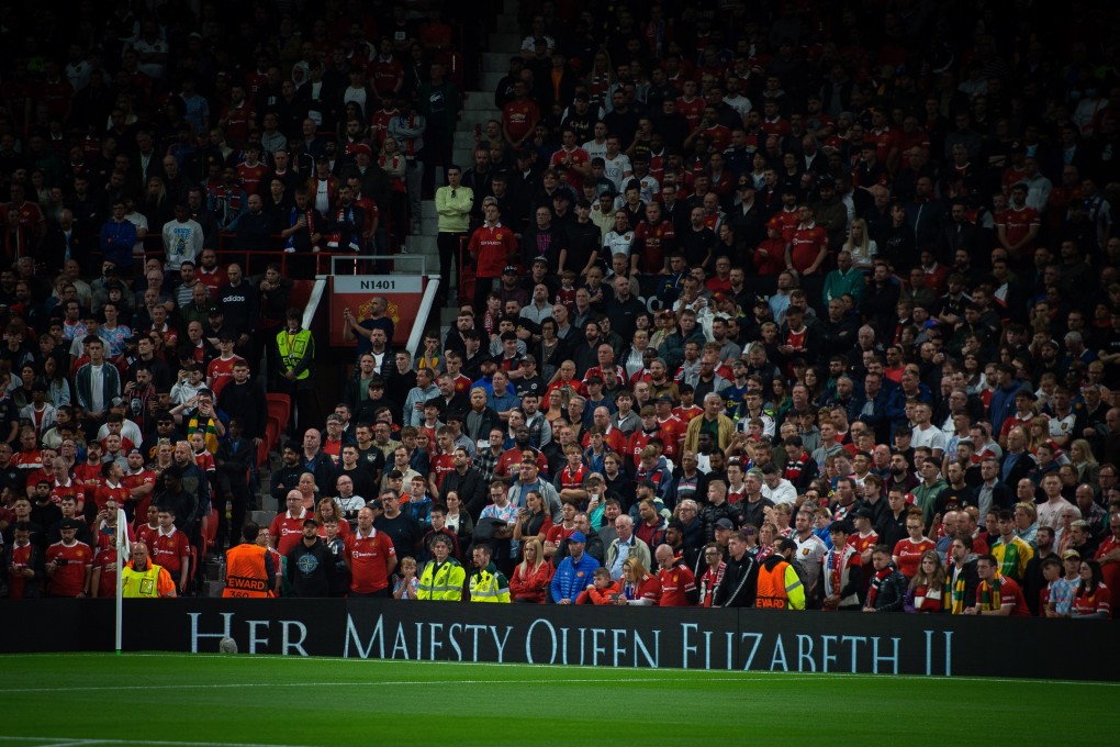 Fans stand in silence to honour HRH Queen Elizabeth II before a match between Manchester United and Real Sociedad. Photo: EPA-EFE