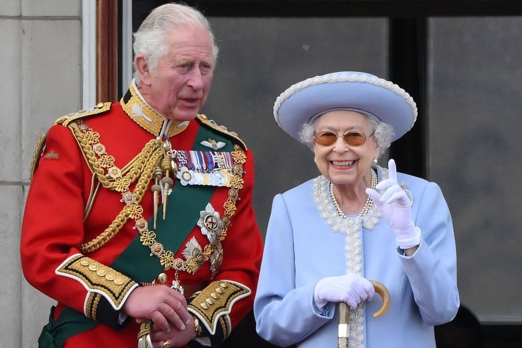 Britain’s Queen Elizabeth stands with Prince Charles, left, at Buckingham Palace during a special flyover following the Trooping the Colour in June. Photo: AFP