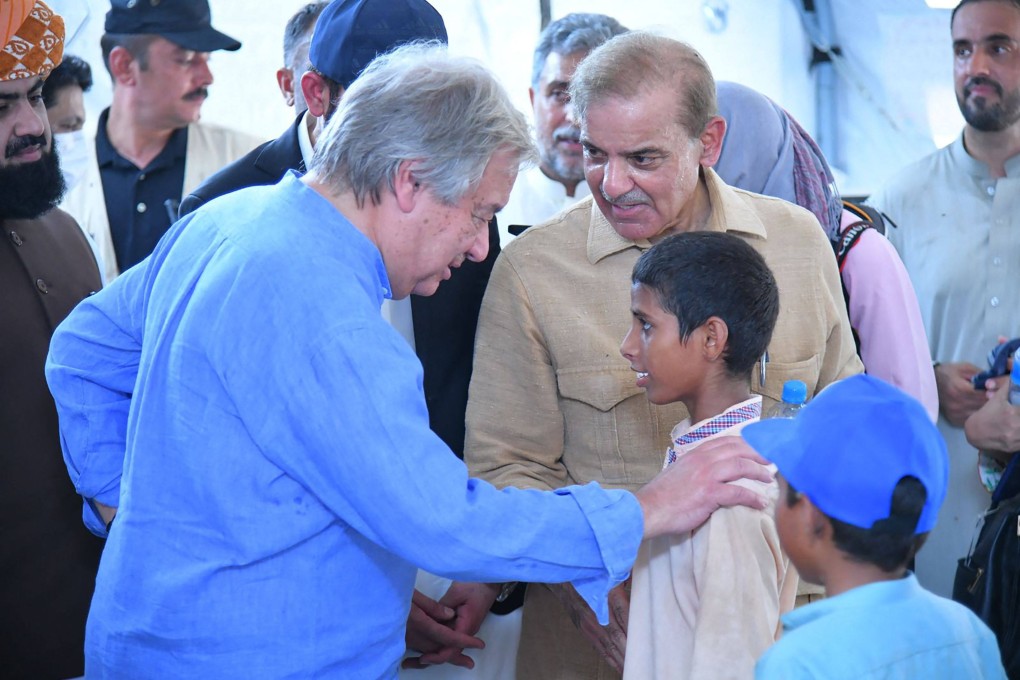 United Nations Secretary-General Antonio Guterres, left, and Pakistan’s Prime Minister Shehbaz Sharif, meeting internally displaced children at a makeshift camp during a visit to flood-affected areas. Photo: AFP
