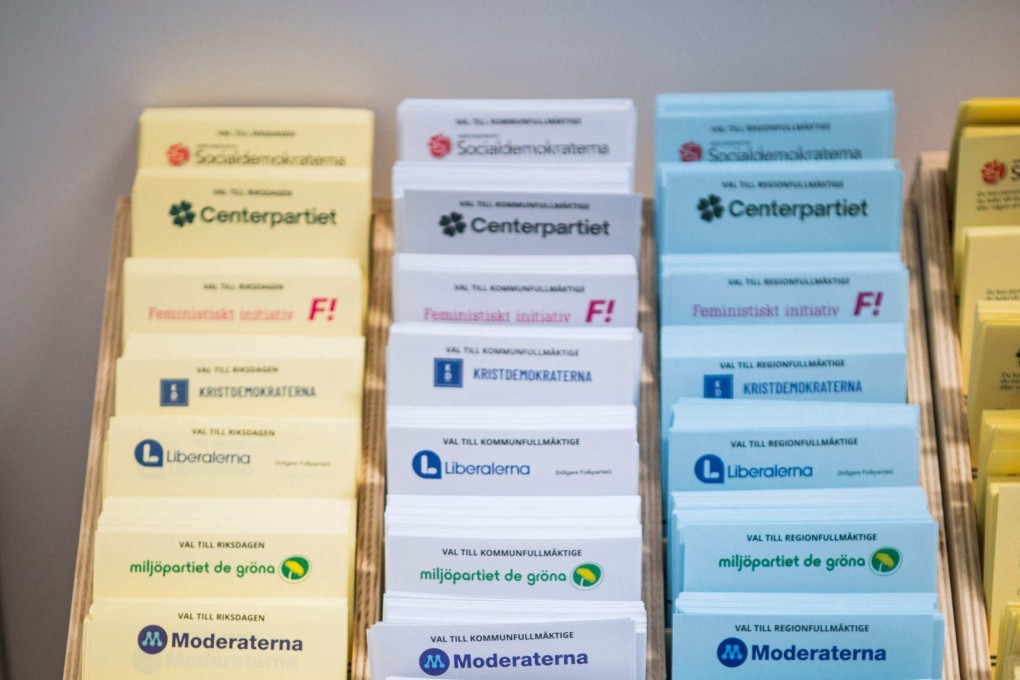 Voting ballots for different political parties displayed inside a polling booth at a polling station in Stockholm, Sweden, during a pre-voting for the Swedish elections. Photo: AFP