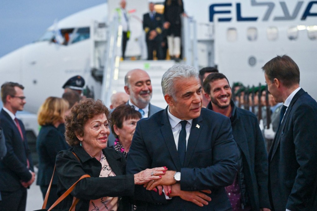 Israeli Prime Minister Yair Lapid arrives with a Holocaust survivor at Berlin Brandenburg Airport on Sunday. Photo: Koby Gideon / GPO / dpa