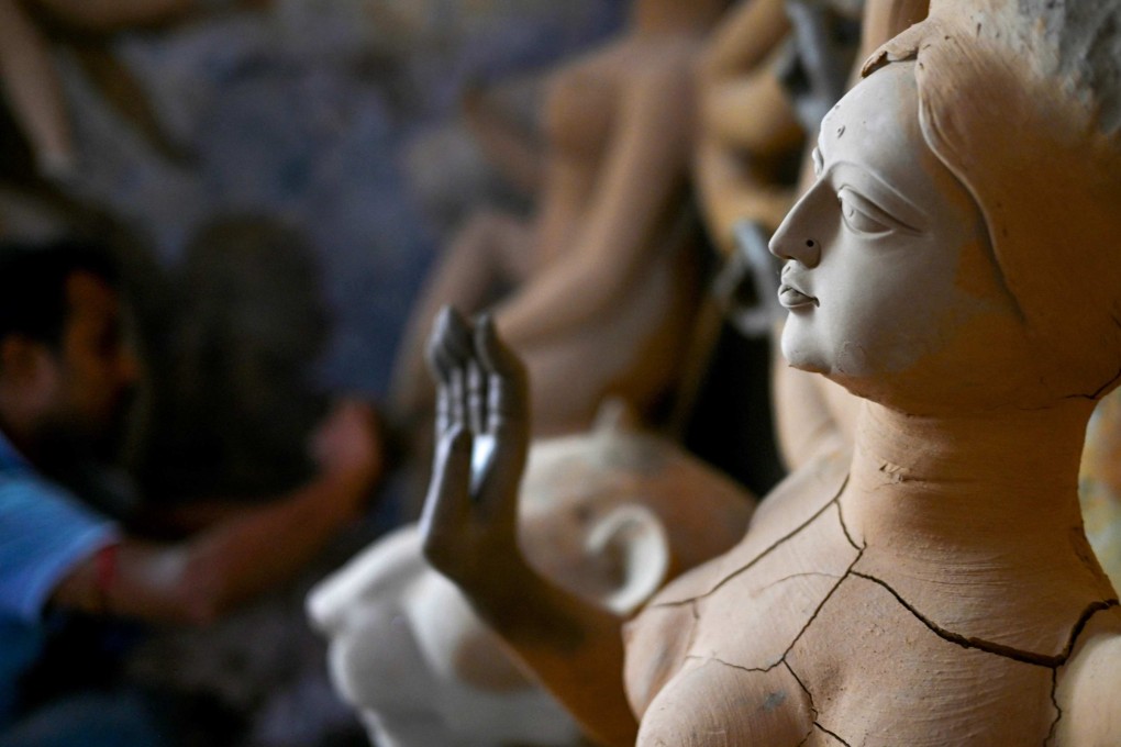 An artisan sculpts a clay idol of a Hindu goddess at a workshop in New Delhi earlier this month ahead of a religious festival. Photo: AFP