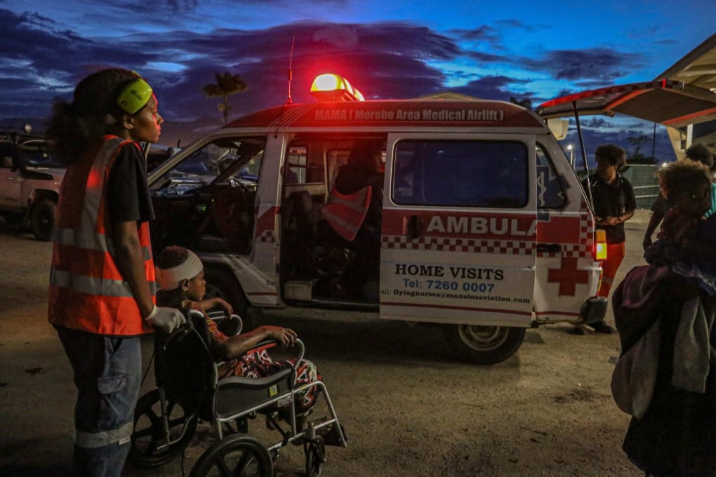 Injured villagers arrive at a hospital after being evacuated via helicopter in Papua New Guinea on Sunday. Photo: AFP