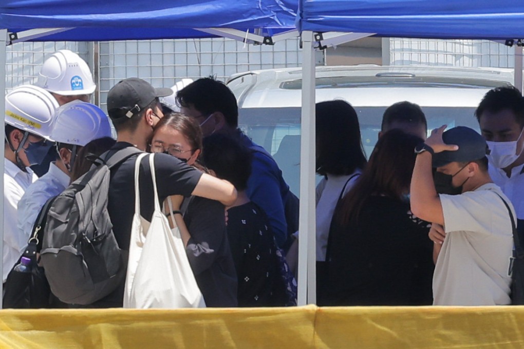 People comfort family members of the victims of an accident at a construction site. Photo: Jelly Tse