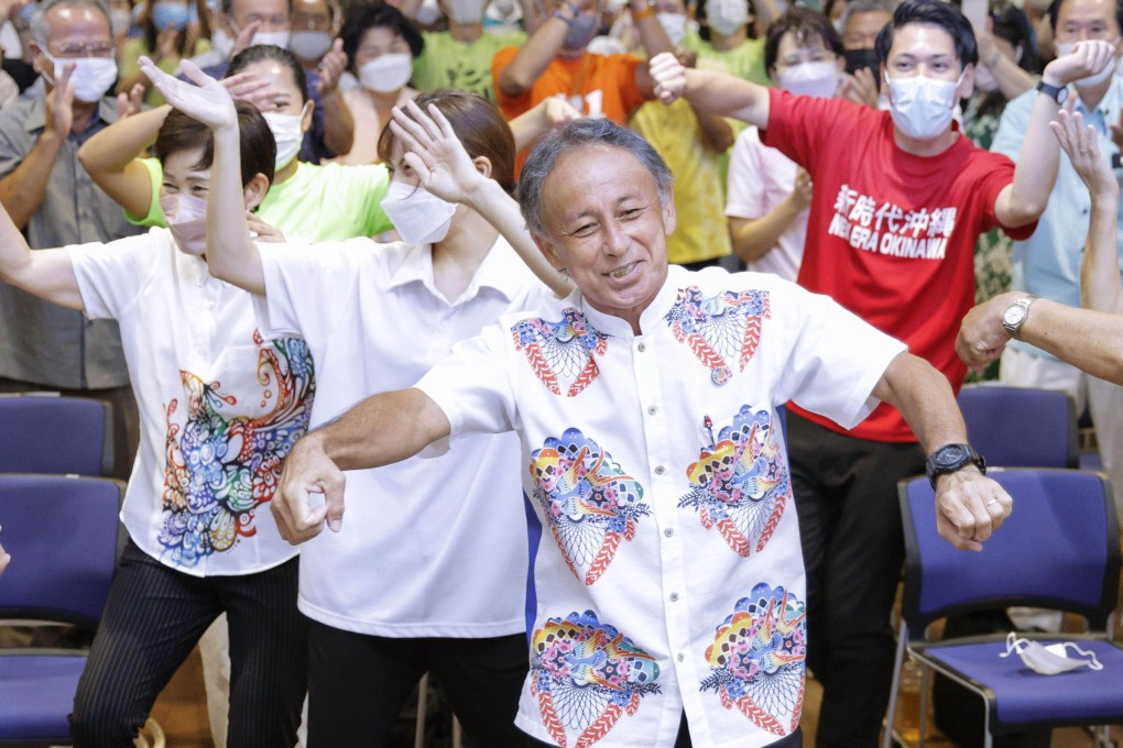 Okinawa Governor Denny Tamaki performs a traditional folk dance with his supporters on Sunday after winning a second four-year-term. Photo: Kyodo
