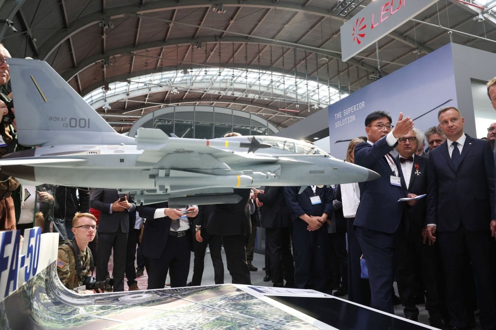 Polish President Andrzej Duda speaks with Lee Bong Keun representative of Korea Aerospace Industries Ltd stand near model of multi-role platform FA-50 nn Kielce, Poland on September 5. Photo: Reuters
