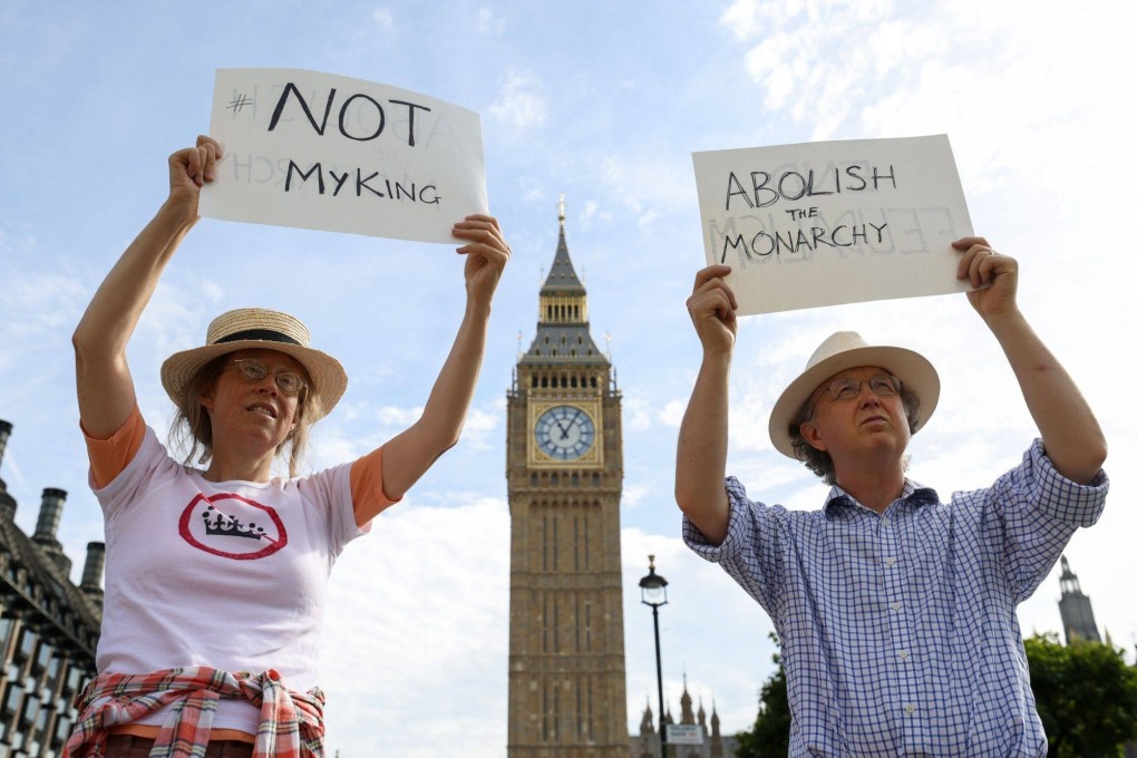 Protesters hold placards reading “Not My King” and “Abolish The Monarchy” in London on Monday. Photo: Bloomberg