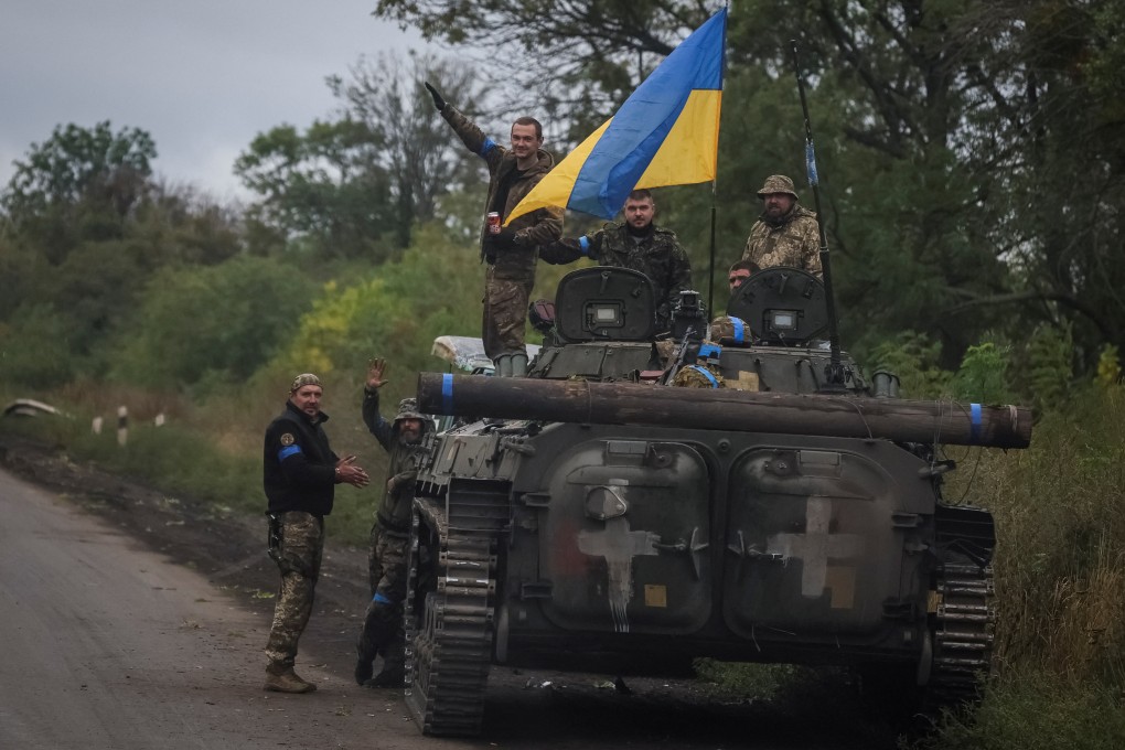 Ukrainian service members on Wednesday stand on an infantry fighting vehicle near the town of Izium, recently liberated from Russian forces. Photo: Reuters