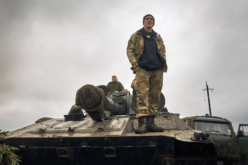 A Ukrainian soldier stands on a tank on the road in the freed territory of the Kharkiv region on Monday. Photo: AP