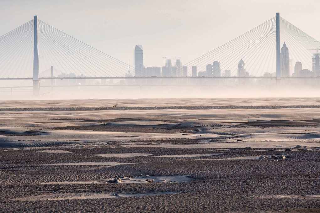 The parched bed of a section of the Yangtze River is seen in Wuhan, in central Hubei province, on September 2. Heatwaves and drought have been common across the Northern Hemisphere this summer, drying up rivers and disrupting commerce and power generation. Photo: AFP