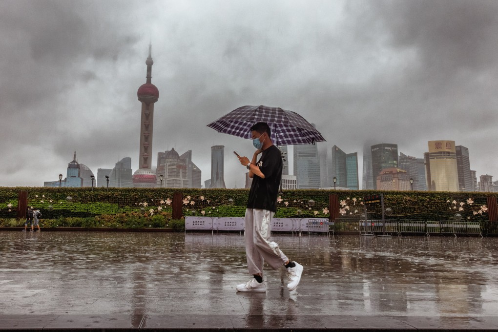 A man walks in Shanghai as Typhoon Muifa loomed on Wednesday. Shanghai grounded all flights from Pudong and Hongqiao airports, halted port operations, closed subway stations and limited speed for ground trains. Ningbo, Taizhou, and Zhoushan city were ordered to suspend classes for the day. Photo: EPA-EFE
