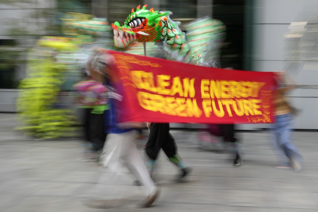 Filipino climate activists run with a banner saying “Clean Energy, Green Future” during a rally outside the Chinese consulate in Makati, Philippines, in October 2021. The group welcomed the announcement by Chinese President Xi Jinping that his country will no longer fund coal-fired plants abroad. Photo: AP