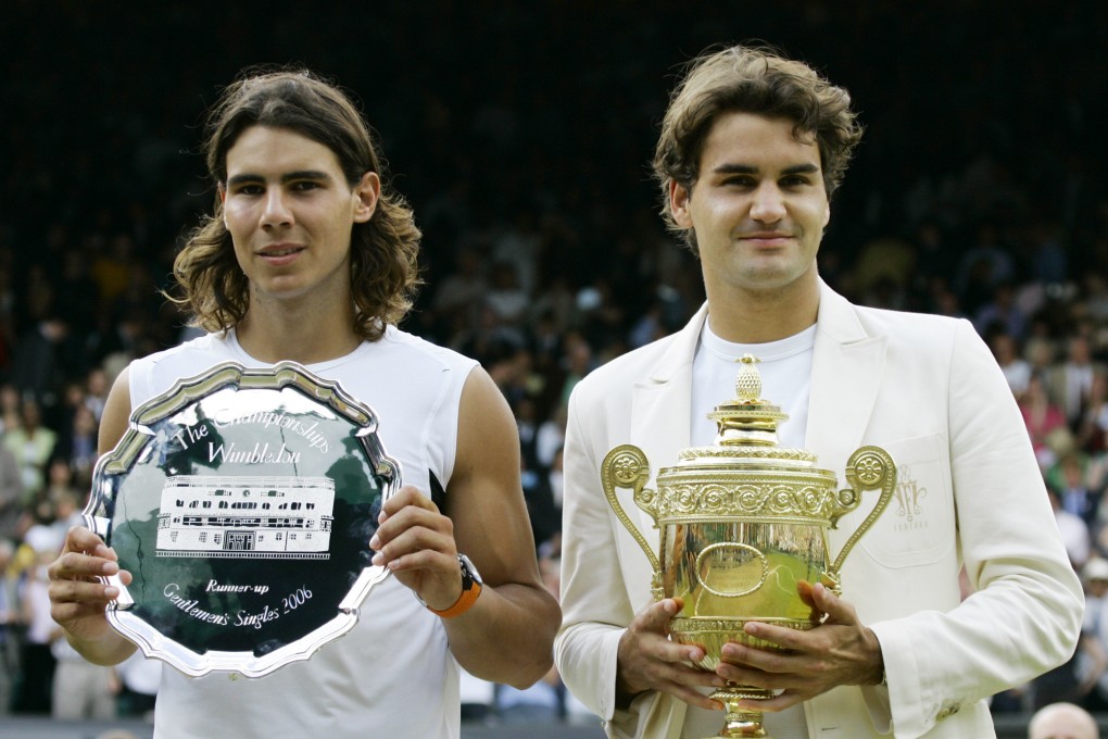 Roger Federer holds the winners’ trophy next to runner-up Rafael Nadal after the 2006 Wimbledon final. Photo: AP