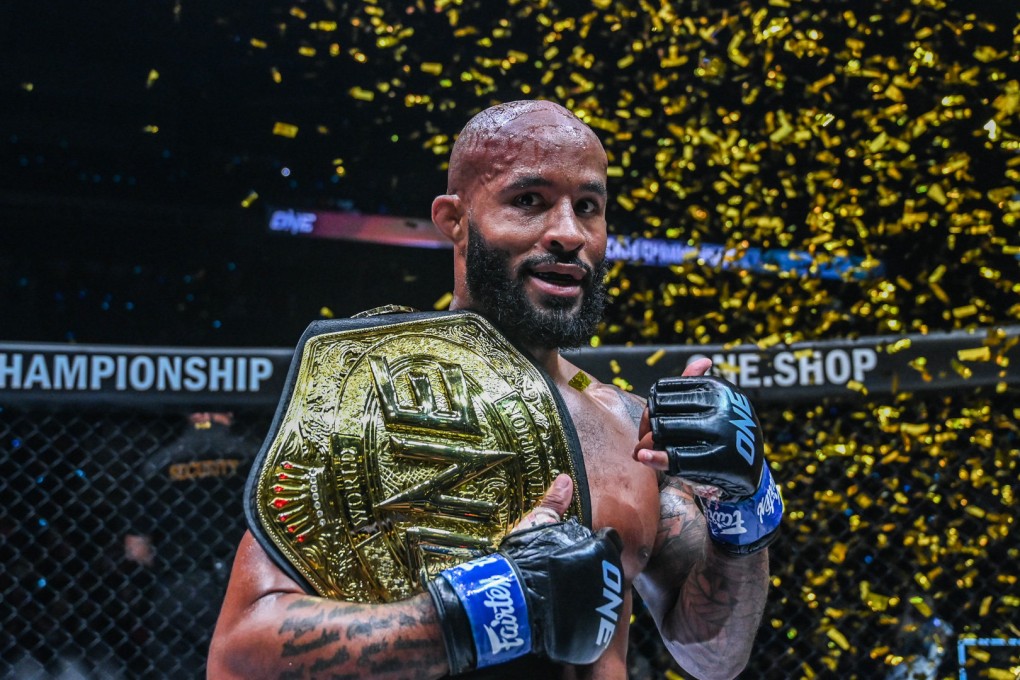 Demetrious Johnson poses with the ONE flyweight MMA title after knocking out Adriano Moraes.