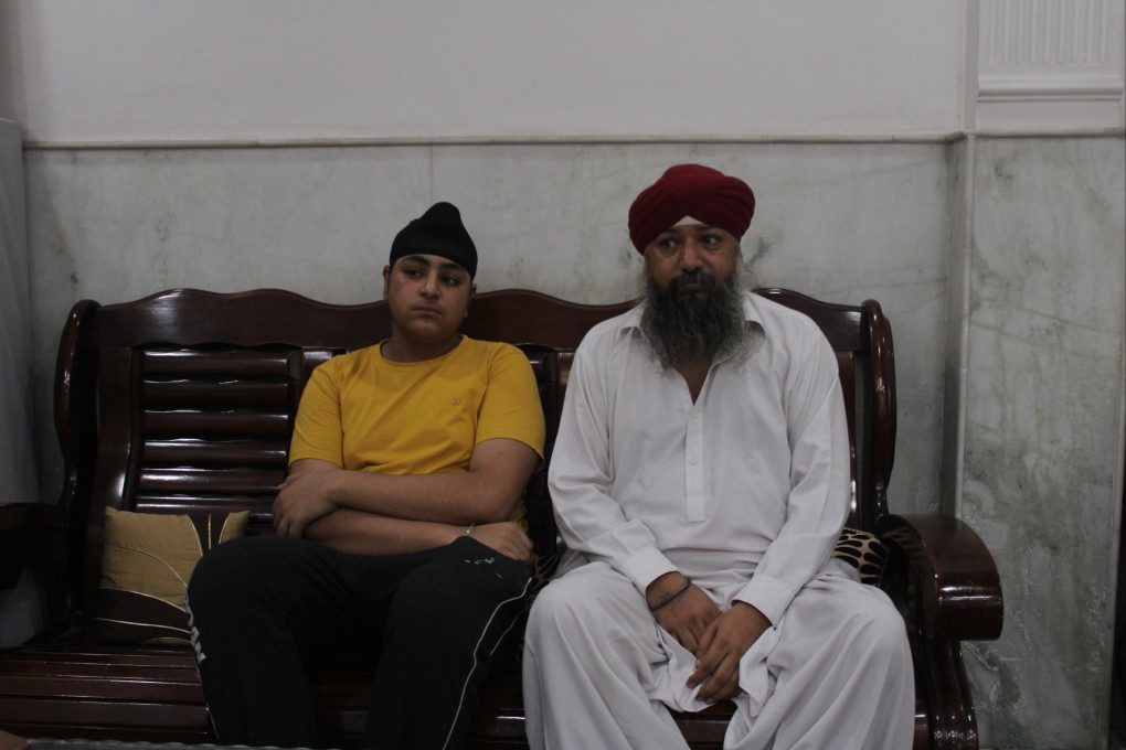 Manmohan Singh, 45, with his son Sandeep in New Delhi. The family has been looked after there by the Afghan refugee Sikh community since fleeing to India last month. Photo: Bilal Kuchay