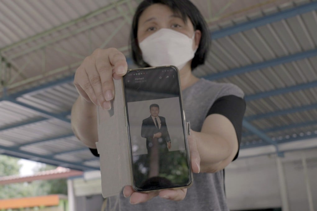 Malaysian Yang Fei Pin holds her phone showing a photograph of her late son Goi Zhen Feng. Photo: SCMP / Aidan Jones