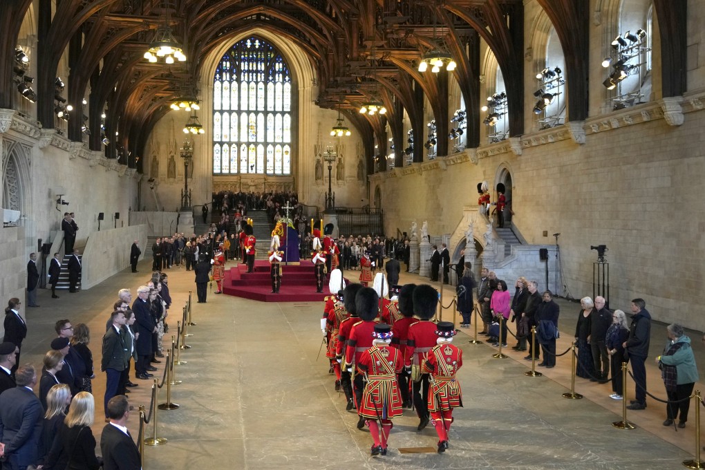 The changing of the guard takes place as members of the public file pass the coffin of Queen Elizabeth lying in state in Westminster Hall. Photo: AP