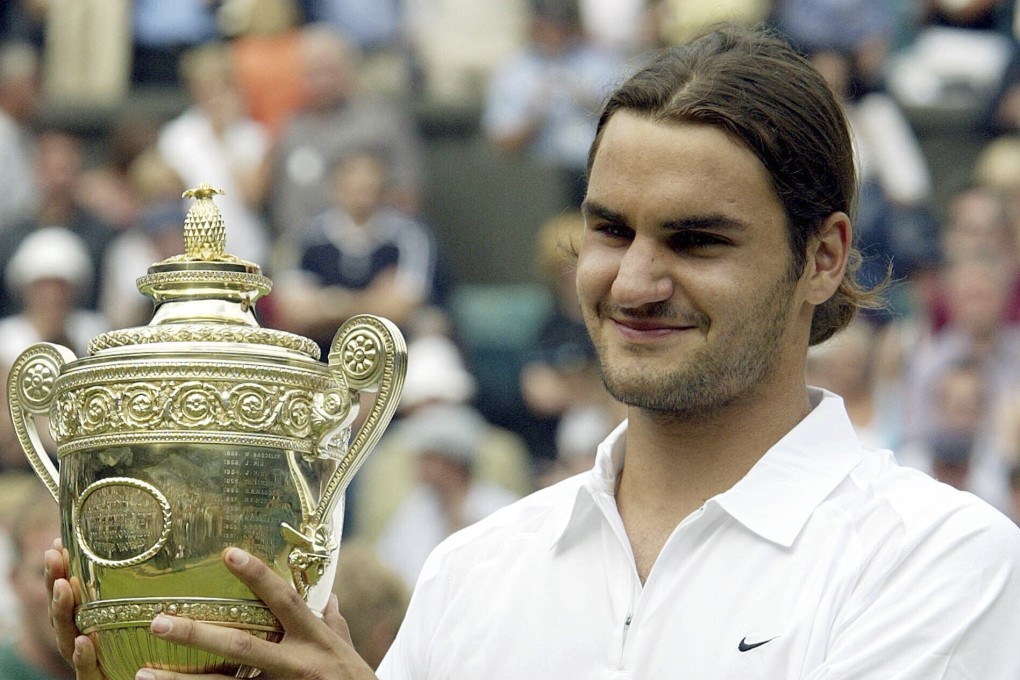 Switzerland’s Roger Federer holds the men’s singles trophy after defeating Australia’s Mark Philippoussis in the 2003 Wimbledon final. Photo: AP